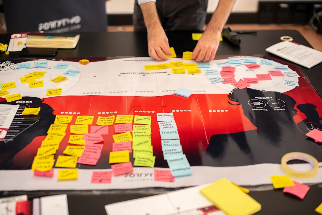 A modern workspace showing hands analyzing marketing data on a laptop and paper documents.